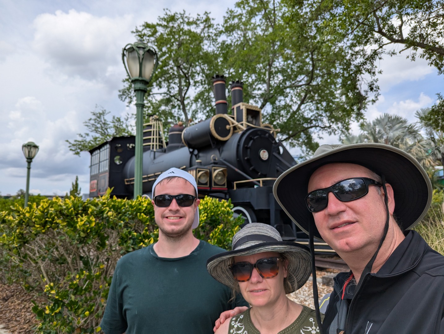 All three of us by the train in 2025